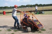 Dad pushes Jacob to grid.